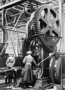 Wartime empowerment: Women operating shell case machinery, 1916.