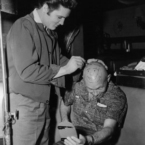 Elvis doodles on makeup artist Jack Stone's head.