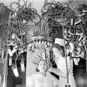 Beauty school, glamorous Hollywood-style permanent waves, 1940s.