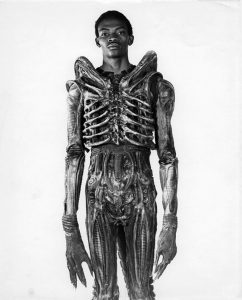 Bolaji Badejo wearing his costume from the sci-fi thriller Alien, 1978.