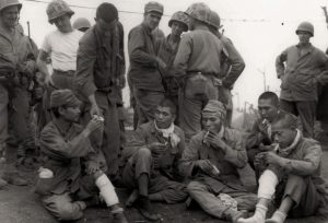 Captured Japanese soldiers being offered cigarettes. Iwo Jima, 1945. 