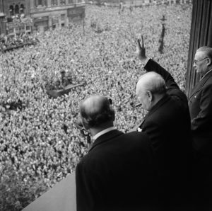 Churchill waving to the cheering crowds.