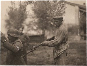 Liberated Jewish man holds NAZI soldier at gunpoint during WWII, unknown date 