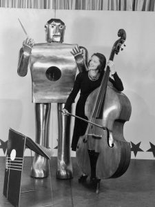 Lois Kendall playing the bass with robot 