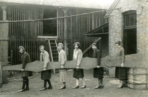 6 Women holding the minute hand of the Singer clock in 1926.
